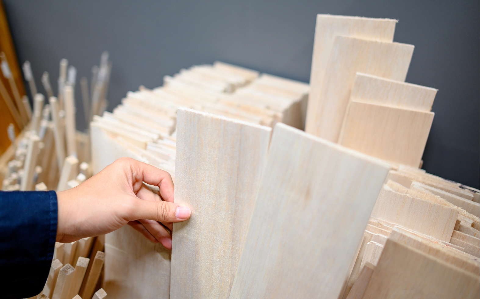 Hand picking light wood planks