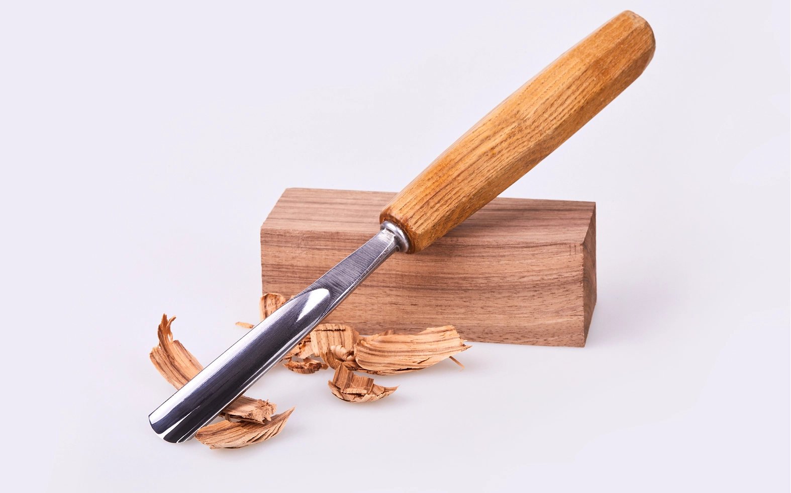 Chisel on wooden block with shavings